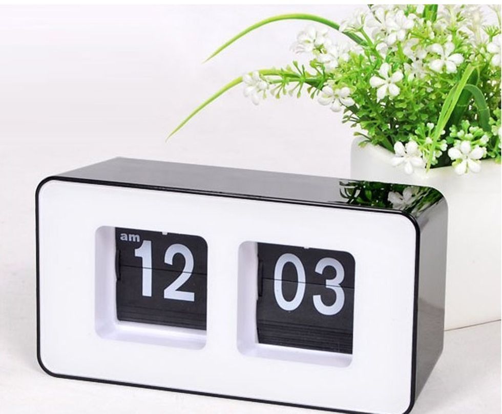 A clocking displaying the time 12:03 AM.