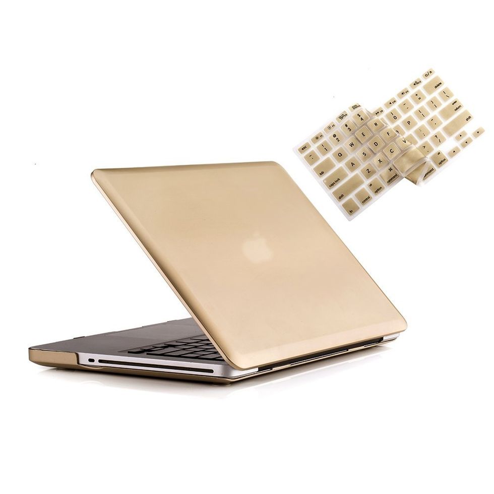 A laptop with a gold colored cover and keyboard cover that is also gold.