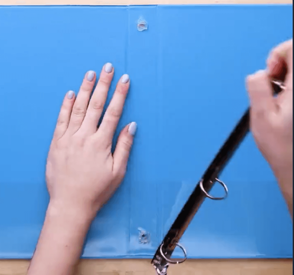 Someone rips the metal rings out of a trapper keeper