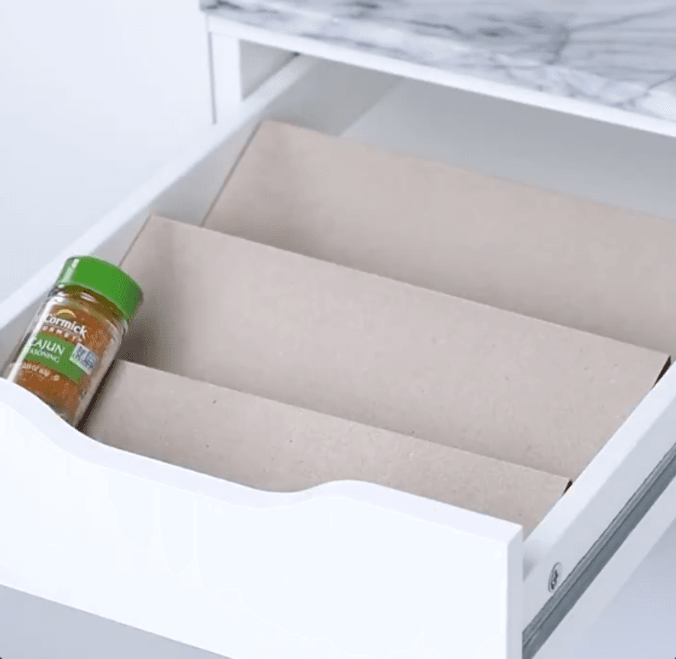 Three ramps in a drawer one after the other. On the first one there's a spice jar.
